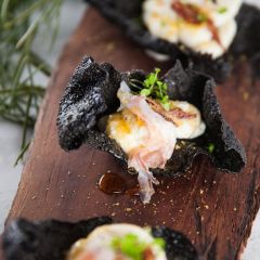 Squid ink rice crisps with whipped buffalo ricotta